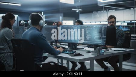 Team of Talented Young Professionals Working in a Technological Research and Development Agency. Young Female Developer Working with AI Software and Mapping Technical Neural Network Data Set Stock Photo