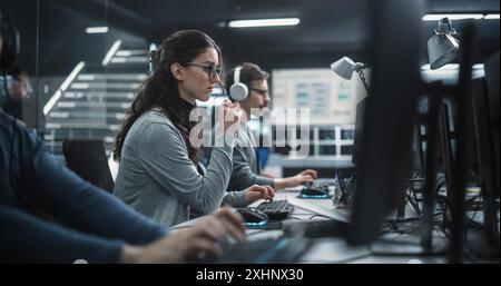 Portrait of a Thoughtful Female Engineer Working on Computer in a Technological Office Environment. Research and Development Department Writing Software Code for an Innovative Internet Project Stock Photo