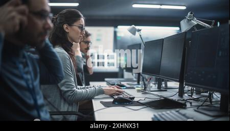 Portrait of a Thoughtful Female Engineer Working on Computer in a Technological Office Environment. Research and Development Department Writing Software Code for an Innovative Internet Project Stock Photo