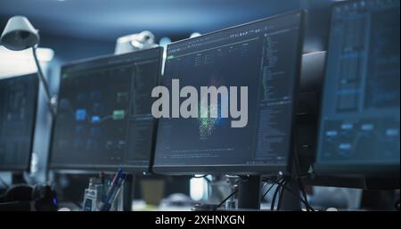 Empty Software Developer Office Workplace with a Desk with Multiple Computer Screen with Programming Code, Big Data Models, Back-End of Artificial Intelligence and Neural Network Technology Systems Stock Photo