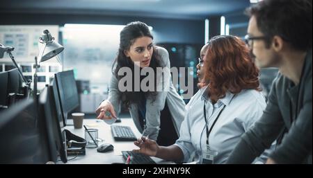 Team of Three Multiethnic Diverse Software Developers Talk, Discuss an AI Project. Empowered Black Female Specialists and Two Colleagues Work on Digital E-Commerce Startup Business Stock Photo