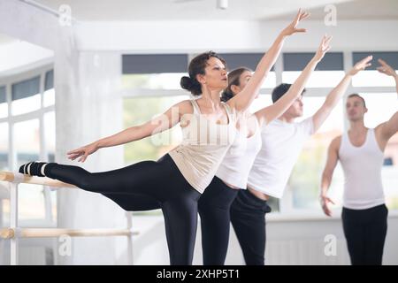 Pretty female ballerina practicing arabesque pose. Stock Photo