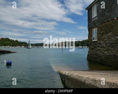 Family fun people enjoy crabbing off jetty in Salcombe, South Hams, Devon, UK Stock Photo