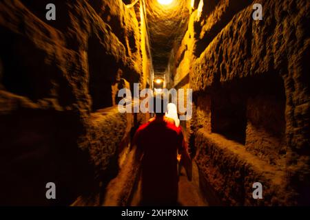 Visitors walking in  Christian Catacombs of Callixtus. Rome, Italy. Stock Photo