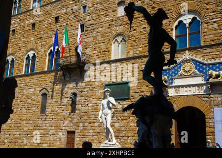 Copy of Michelangelo's David statue and Perseus with the Head of Medusa shadowed in the foreground. Palazzo Veccio, Florence, Tuscany, Italy. Stock Photo