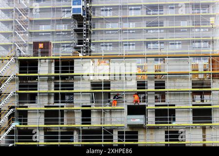 Capturing the industrious spirit of Zurich, this image showcases workers diligently performing tasks on a scaffold, contributing to the city's ever-ev Stock Photo