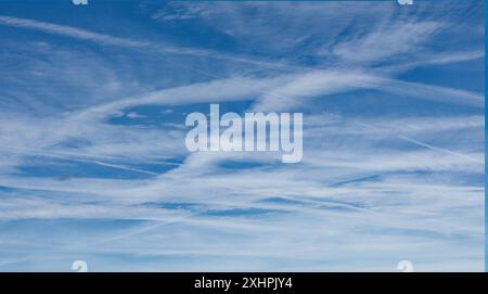 Glasgow, Scotland, UK. 15th July, 2024: UK Weather: Sunny day and a busy sky saw chemtrails type blue sky  north of the city airport. Credit Gerard Ferry/Alamy Live News Stock Photo