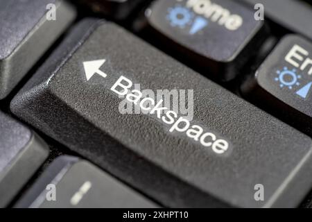 Simple backspace key on a modern laptop computer keyboard macro detail extreme closeup nobody Ctrl z, coming back correcting deleting removing undoing Stock Photo