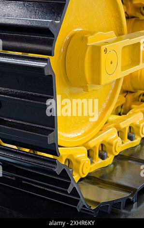 Chassis of a generic crawler tractor or excavator, close up shot, abstract industrial background Stock Photo