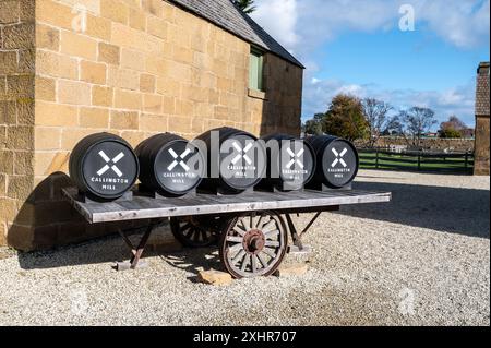 An old wheel cart with a load of restored wooden barrels at the Callington Mill was built in 1837 in Oatlands, Tasmania, Australia. Stock Photo