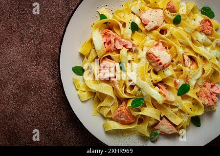 Tagliatelle pasta, in cream sauce with salmon, homemade, no people Stock Photo