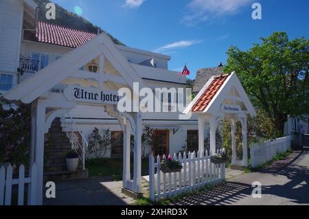 Historic wooden hotel with white facades, red roofs, flowers and blue sky, Edvard Grieg, Utne, Hardanger, Hardangerfjord, Norway Stock Photo