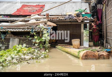 Morigaon, India. 4 July 2024. Residents in their flooded house, in a flood affected village in Morigaon district in India's northeastern state of Stock Photo