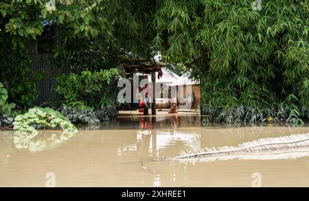 Morigaon, India. 4 July 2024. Residents in their flooded house, in a flood affected village in Morigaon district in India's northeastern state of Stock Photo