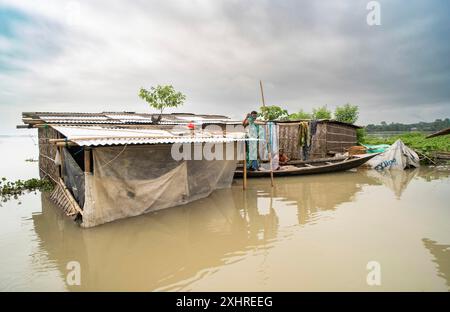 Morigaon, India. 4 July 2024. Residents in their flooded house, in a flood affected village in Morigaon district in India's northeastern state of Stock Photo