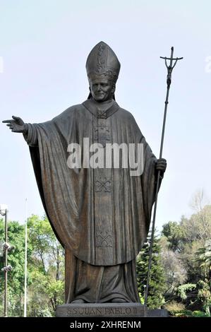 Monument to Pope John Paul II with believers, Mexico City, Mexico, Central America, Statue of a pope with raised arm and cross staff outdoors Stock Photo