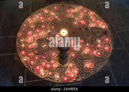Burning devotional candles on sand in the Lorenzkirche, Nuremberg, Middle Franconia, Bavaria, Germany Stock Photo