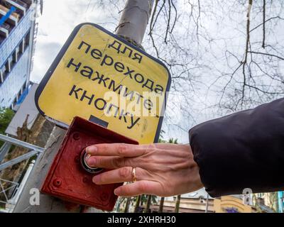 Turning on a green pedestrian traffic light using a button Stock Photo