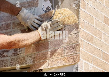 Flexible thin faux brick panels are composed of marble chips, acrylic water dispersion and coloring pigments. Stock Photo