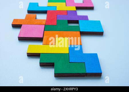 Colored parts of a logical puzzle, jigsaw puzzle. Solving complex problems, logical thinking. Stock Photo
