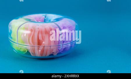 Container with colorful rubber bands Stock Photo