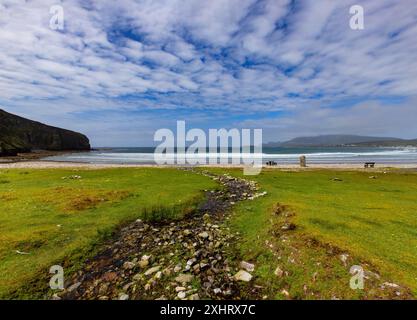 The stream from the waterfall cascading to  Keel Bay beach below Minaun Heights  on Achill Island, County Mayo, Ireland Stock Photo