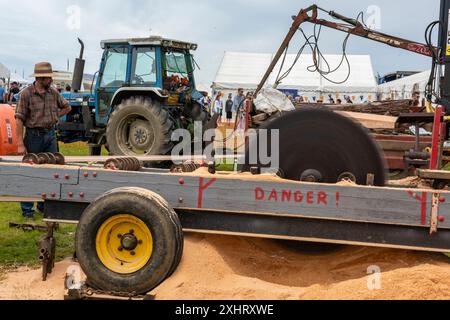 vintage tractor powered agricultural commercial saw mill operating at an agricultural show on the isle of wight uk Stock Photo