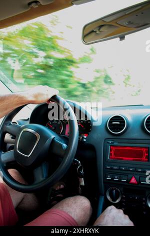 Cropped close up of young man driving on car road trip Stock Photo