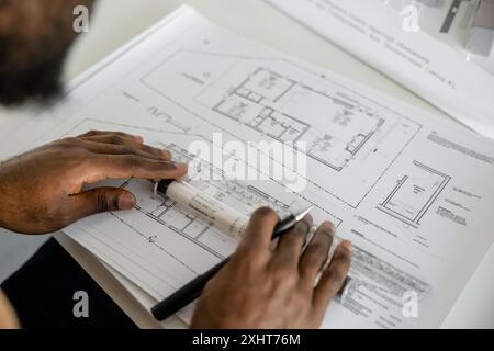 Dedicated man architect overseeing real estate projects in his office Stock Photo