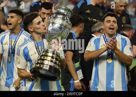 Miami, Florida, USA. 15th July, 2024. Argentina's forward Julian Alvarez celebrates with the trophy after his team defeating 1-0 to Colombia and winning the Copa América USA 2024 final match between Argentina and Colombia, at Hard Rock Stadium, on July 14, 2024. Credit: Alejandro Pagni/Alamy Live News Stock Photo