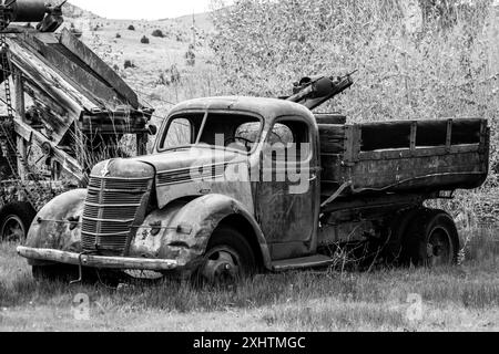 Black and white image of an old truck with old mining equipment, from old mining town. Stock Photo