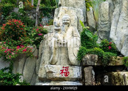 stone Monument in Luhuitou Park. The park deer turned its head, May 16, 2024, Sanya, Hainan, China. Stock Photo