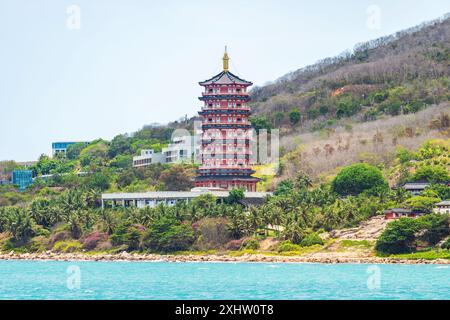 Duobao Stupa and palm tree in center of Buddhism Nanshan, Hainan, China Stock Photo