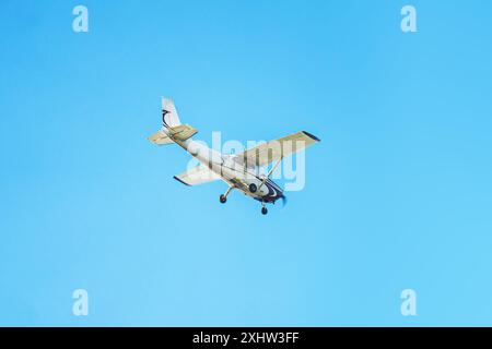 Small airplane against blue sky Stock Photo
