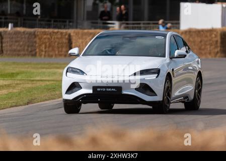 2024 BYD Seal electric car driving up the hill climb track at the Goodwood Festival of Speed 2024 motorsport event in West Sussex, UK Stock Photo