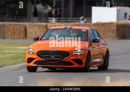 2024 Genesis G70 Track Taxi Nordschleife driving up the hill climb track at the Goodwood Festival of Speed 2024 motorsport event in West Sussex, UK Stock Photo