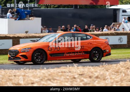 2024 Genesis G70 Track Taxi Nordschleife driving up the hill climb track at the Goodwood Festival of Speed 2024 motorsport event in West Sussex, UK Stock Photo