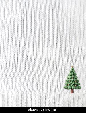 Vertical Christmas background Wool sweater texture of white color with border and felt Christmas tree. Background for scrapbooking design, holiday dec Stock Photo