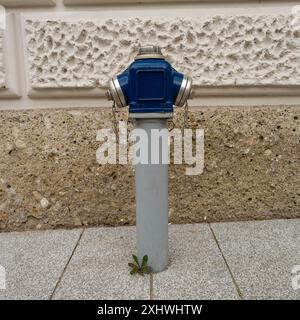 Salzburg, Austria. July 1, 2024. a fire hydrant on the sidewalk of a street in the city center Stock Photo