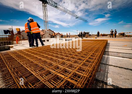 Pile of rusty quadratic steel reinforcement mesh, rebar, grid for concrete is placed at the construction site. Stock Photo