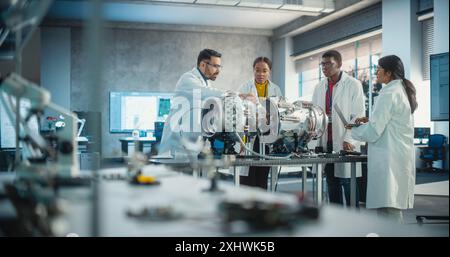 Young Female Black Engineer Leading her Team, Analyzing and Researching How a Futuristic Turbofan Motor Works. Diverse Scientists Developing Innovative Technology in Industrial High Tech Facility Stock Photo