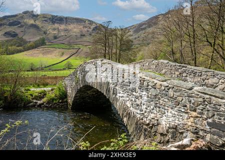 New stone bridge across River Derwent in spring Rosthwaite Borrowdale Valley Lake District National Park Cumbria England UK Britain Stock Photo