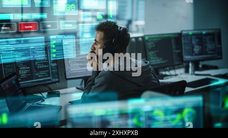 Software Developer Working on Computer, Engineering Neural Networking, Machine Learning, Big Data, Artificial Intelligence. Edited Coding Language Projection Overlayes the Screen. Back View Shot Stock Photo