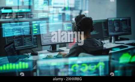 Software Programmer Working on Computer, Engineering Neural Networking, Machine Learning, Big Data, Artificial Intelligence. Edited Coding Language Projection Overlayes the Screen. Back View Shot Stock Photo