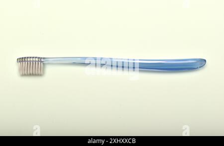 Transparent toothbrush on a green background. Stock Photo