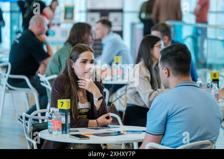Moscow - April 10,2024: Professionals networking and engaging in discussions at business event Open Innovations Conference in Skolkovo Technopark at modern hall Stock Photo