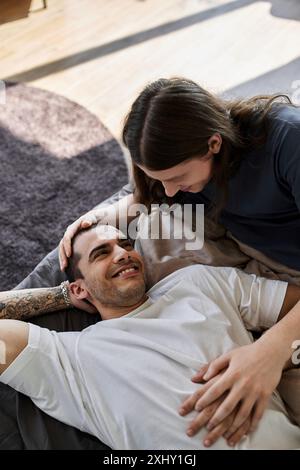 A young gay couple spends a quiet moment together in their bedroom, sharing a tender and loving embrace. Stock Photo