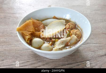 boiled meatball made from fish and shrimp with dumpling  couple bean sprout in spicy tom yum soup on bowl Stock Photo