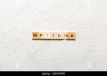 WELCOME word written on wood block. WELCOME text on table, concept. Stock Photo