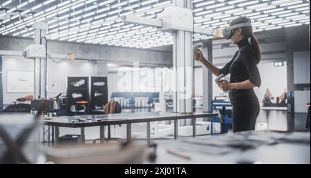 Female Car Designer Wearing Virtual Reality Headset and Using Controllers to Work on a Concept Car Made Out of Plasticine Modeling Clay. Talented Designer Working in VR Set to Analyze the Vehicle Stock Photo